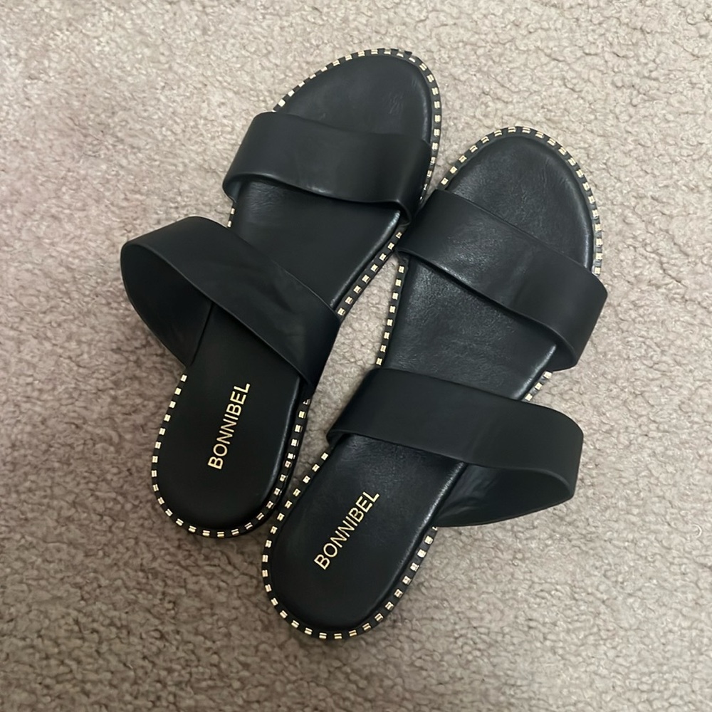 Black sandals with gold trim